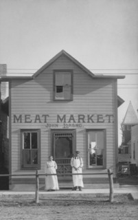 Two People Standing in Front of Meat Market, USA, circa 1900