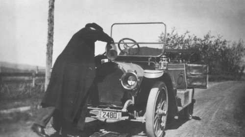 Man Pouring Water in Radiator of Automobile, circa 1912