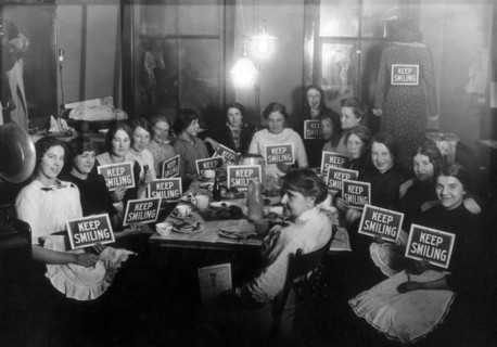 Seamstresses on Lunch Break, Holding Keep Smiling Signs, circa 1914