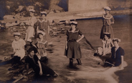 Group of Women in One-Piece Bathing Suits Wading and Sitting in Stream, circa 1907