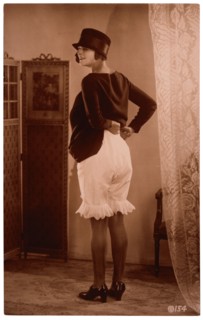 French Lingerie Model Lifting Dress to Reveal Bloomers, Rear View, 1915