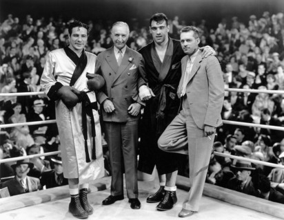 Max Baer (left), Primo Carnera (second from right), director W.S. Van Dyke (right) on-set of the Film, "The Prizefighter and the Lady", 1933