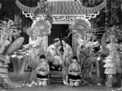 Nick Lucas, Myrna Loy, on-set of the Film, "The Show of Shows", 1929