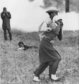 Civil Rights Demonstrator Helping Young Woman After Police Toss Smoke Bombs, Camden, Alabama, USA, 1965
