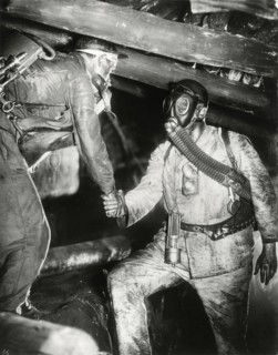 Two Miners, one Wearing Gas Mask, Shaking Hands, on-set of the Film, "Kameradschaft", 1931
