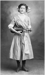Young Woman with Lace-Up Shoes Standing with Violin and Bow, Postcard, circa 1910