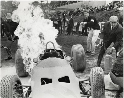 Technicians Attempt to Extinguish Flames of Burning Yamura Racer from the Film, "Grand Prix", MGM, 1966