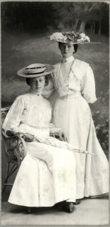 Two Women in White Dresses and Hats, One Seated Holding Parasol, Portrait, Stuttgart, Germany, circa 1900,