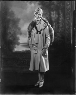 Fashionable Woman in Short Dress and Coat with Mink Fur Stole and Knit Cap, Portrait, circa 1923