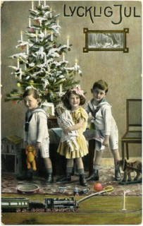 Three Children with Presents and Train Set in Front of Christmas Tree, "Lycklig Jul", Postcard, Sweden, circa 1912