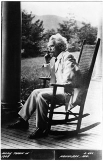 Samuel Langhorne Clemens, or better known as Mark Twain (1835-1910), American Writer and Humorist, Portrait in Rocking Chair Smoking Cigar, circa 1908
