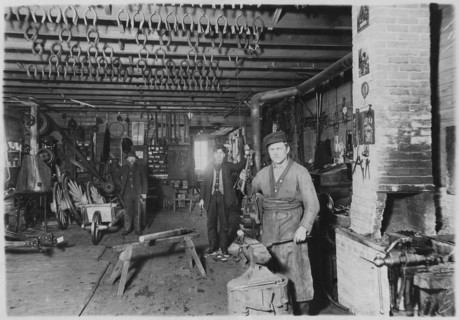 Blacksmith in Cartwright shop, circa 1890