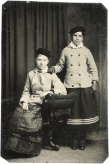Portrait of Two Adult Women, One Seated, One Standing, with Matching Hats and Jackets, circa 1870