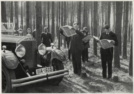 Adolf Hitler and Entourage Standing Alongside his Mercedes while Reading Newspapers in the Woods, Germany, early 1930's