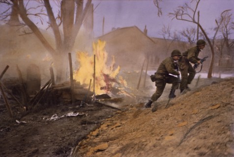 Infantrymen Moving Past Fire Started by Enemy Shelling, Rhineland Campaign, Germany, 1945