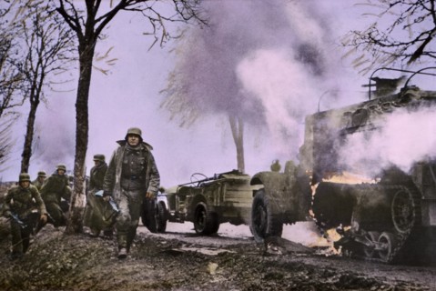 Enemy Troops Passing Burning U.S. Equipment, Ardennes-Alsace Campaign, Battle of the Bulge,1945