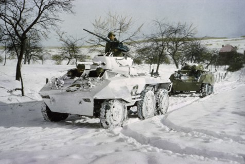 Camouflaged Light Armored Car M8 and one that was not Painted White, Ardennes-Alsace Campaign, Battle of the Bulge, 1945
