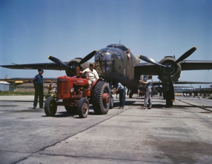 B-25 Bomber Planes Being Hauled along Outdoor Assembly Line by Tractor, North American Aviation, Inc., Kansas City, Kansas, USA, Alfred T. Palmer for Office of War Information, October 1942