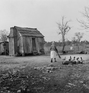 Woman Walking in Yard by Rural Cabin, near Beaufort, South Carolina, USA, Marion Post Wolcott, Farm Security Administration, December 1938