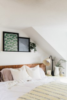 Bed with White Linens and Colorful Artwork