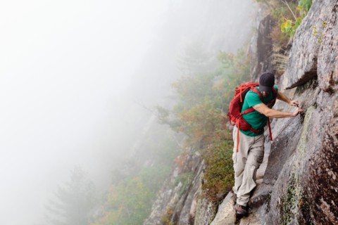 Man Hiking on Cliff on Foggy Day, Acadia National Park, Maine, USA