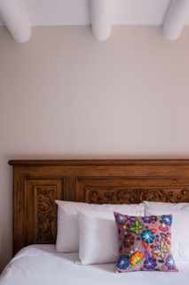 Flowered Pillow on Wood Bed