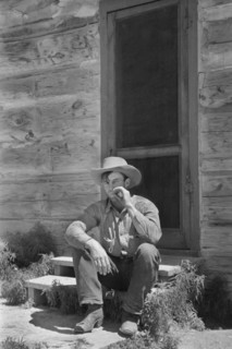 Cowboy Smoking in front of Bunkhouse, Quarter Circle U Ranch, Big Horn County, Montana, USA, Arthur Rothstein, Farm Security Administration, June 1939
