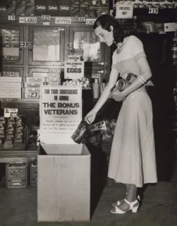 Miss Mary Wick Placing Bag of Coffee in Food Box placed in Stores to Receive Contributions for Encamped Bonus Army Veterans, Washington DC, USA, Underwood and Underwood, June 1932
