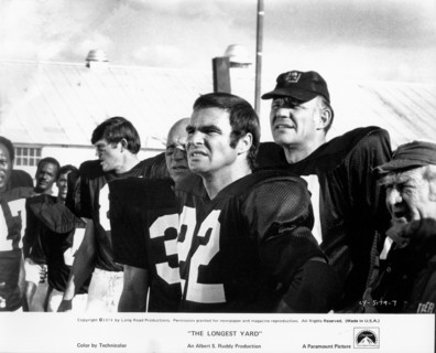 Actor Burt Reynolds, (center), on-set of the Film, "The Longest Yard", Paramount Pictures, 1974
