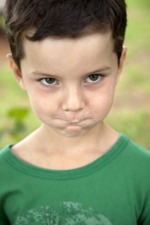Young Boy Making Funny Face With Cheeks and Mouth