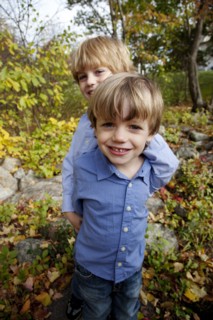 Smiling Boy Standing Behind Another Boy