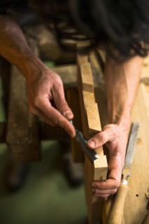Woodworker Using Chisel on Piece of Wood, High Angle View