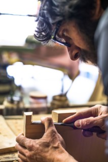 Woodworker Using Chisel on Piece of Wood, High Angle View