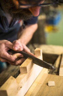 Woodworker Using Rasp on Piece of Wood, High Angle View