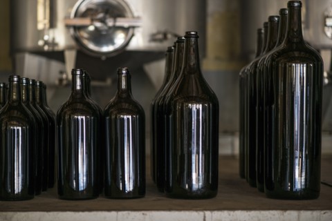 Wine Bottles of Various Sizes in Winery