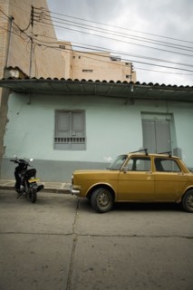 Yellow Car and Motorcyle Parked in Front of Teal House, San Gil, Colombia