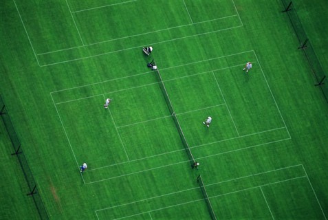 Doubles Tennis Match on Green Court, High Angle View
