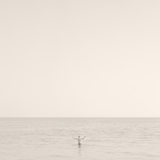 Man Standing in Ocean, Rear View