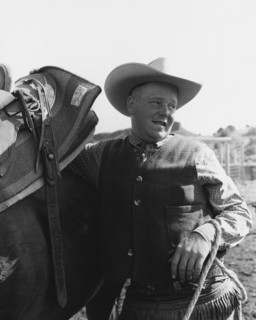 Cowboy Leaning on Horse