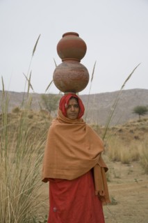 Woman Balancing Clay Pots on Head