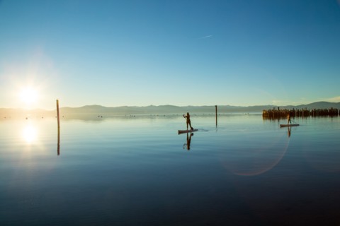 Mother and Daughter on Paddle Boards on Calm Water, Lake Tahoe, Nevada, USA
