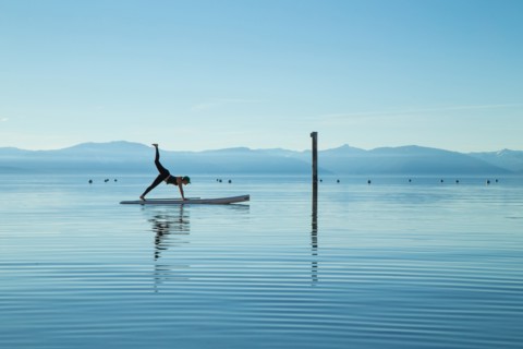 Woman in Yoga Pose on Paddle Board on Lake, Lake Tahoe, Nevada, USA
