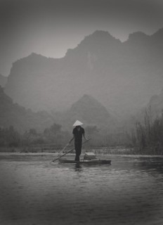 Fisherman Standing on Small Boat, Vietnam