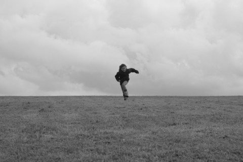 Young Girl Running in Field