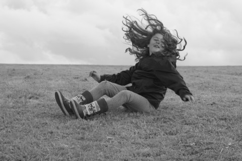 Young Girl Having Fun and Falling on Ground