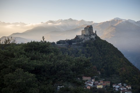 Sacra di San Michele at Sunset with Alps in Background and Village of San Pietro Below, Italy