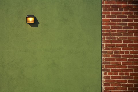 Light Fixture on Green Wall With Red Brick Wall Border
