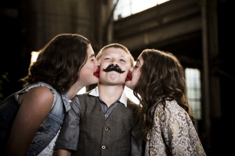 Two Girls Kissing Boy with Wax Lips in Abandoned Warehouse