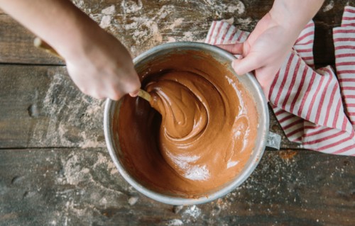 Hands Stirring Cake Batter in Bowl, High Angle View