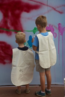 Two Young Boys Painting on Wall